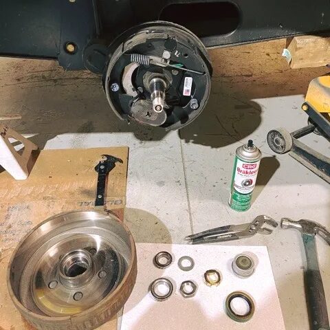 Wheel bearings, drum, and brake assembly disassembled on the bench