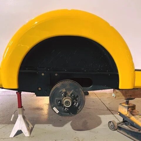 RV axle hub on jack stands with the wheel removed