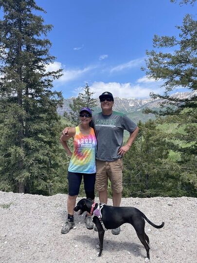 Mark and Carol, owners of Master Tech RV, with their dog in the Colorado mountains